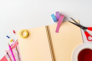Creative workspace setup features colorful supplies and notebook for DIY projects in a bright, organized environment photo