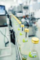Production line of beverage bottling in a modern factory during daytime operations photo