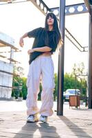 Dancer performs urban choreography outdoors in casual attire during golden hour photo