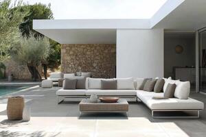 Stylish outdoor lounge area featuring minimalist furniture near a serene pool in a modern landscape setting photo