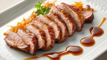 Sliced duck breast drizzled with sauce garnished with herbs and orange zest on a white plate photo