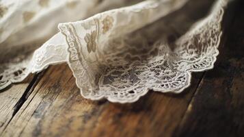 Intricate lace fabric draped gracefully over a wooden surface highlighting artisanal craftsmanship and textile design photo