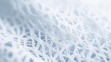 Delicate white lace fabric displaying intricate patterns and textures under soft lighting in a close-up view photo