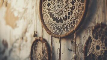 Beautifully crafted dreamcatchers hang against a textured wall, showcasing intricate designs and natural materials photo