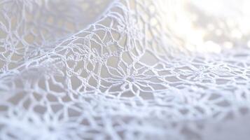 Delicate lace fabric drapes softly to showcase intricate patterns and textures under gentle lighting photo