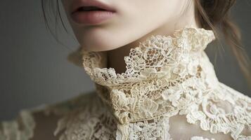 Close-up view of an elegant lace collar on a woman's blouse captured indoors with soft lighting photo