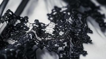 Elegant black lace fabric intricately woven with floral patterns for fashion and design projects photo
