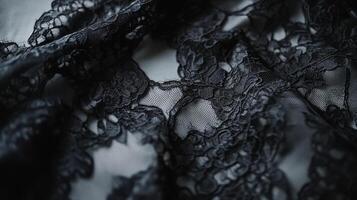 Delicate black lace fabric with intricate floral patterns on a soft background capturing elegance and sophistication photo