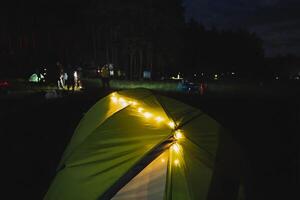 A tent with lights on it at night photo