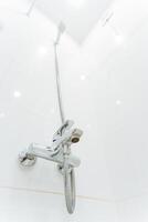 A shower head with a hose attached to it photo
