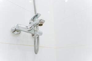 A shower head with a hose attached to it photo