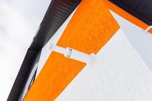A white and orange building with a clock on it photo