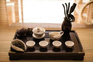 A tray with tea cups and a knife on it photo