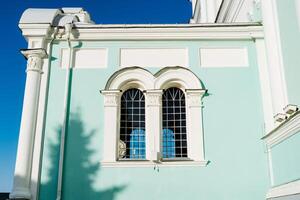 A building with two windows and a clock on it photo