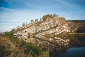 A mountain with a lake and trees reflected in it photo