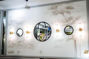 A wall with mirrors and a painting of trees photo