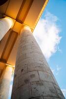 A view of a building with columns and a sky photo