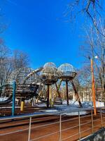 A playground with a large metal structure in the middle photo