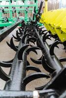 A close up of a machine that is attached to a tractor photo