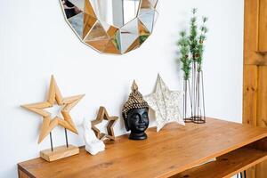 A wooden table with a mirror, star and a christmas tree photo