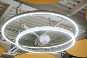 A circular light fixture hangs from the ceiling photo