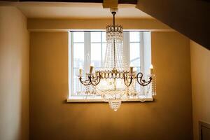 A chandelier hanging from the ceiling in a room photo