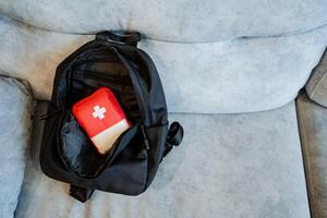A backpack with a red and white flag inside photo