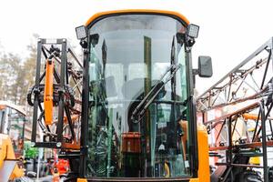 A close up of a tractor with a large sprayer attached photo