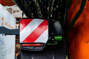 A close up of a tractor with a red and white stripe photo