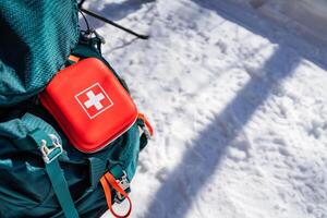 A backpack with an emergency medical kit on top of it photo