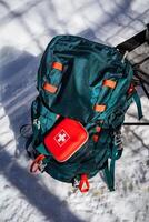 A backpack with a red first aid kit on it photo