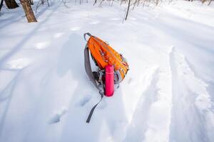 A backpack is sitting in the snow photo