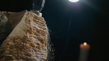 A closeup view of a mysterious rock illuminated with soft candlelight and gentle ambiance video