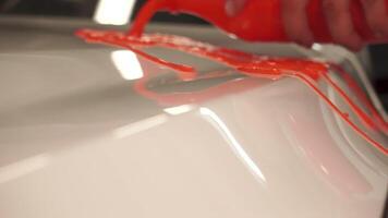 Hydrophobic effect on car paint after using ceramic coating. Footage. Liquid droplets quickly flow down the surface, superfluidity. video
