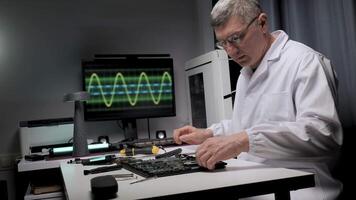 A technician in a white lab coat works diligently on a circuit board. Diagnostic equipment displays waveforms in the background as tools are neatly arranged. video
