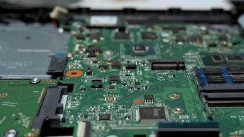 A close-up view of a circuit board showcasing various components like chips, capacitors, and traces. This intricate setup highlights technology and electronics design. video
