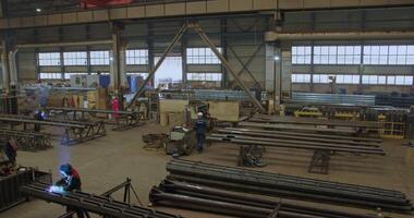 An Industrial Workshop with Machinery and Workers engaged in various collaborative tasks. Media video