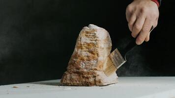 Closeup sculptor works with a special tool for carving stone figures. Cutting stone isolated on black background by hand. Processing with cinematic fragmentation video