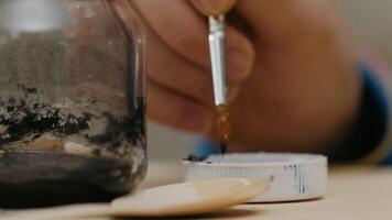 A detailed closeup view of a jar and a spoon resting on a rustic wooden table surface video