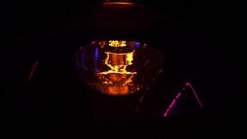 Incandescent lamp with tungsten filament close-up. Footage. The light is flashing due to poor contact. Weak light from a light bulb. Lamp on dark background video