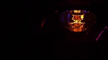Incandescent lamp with tungsten filament close-up. Footage. The light is flashing due to poor contact. Weak light from a light bulb. Lamp on dark background video