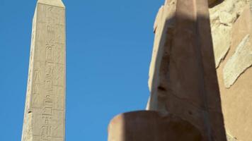View of a tall obelisk in the ancient city of Karnax with an Egyptian statue of a pharaoh video