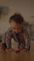 A Child Engaged in Play with a Brightly Colored Toy Car in a Cozy and Comfortable Indoor Setting video