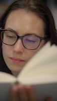 A Focused Reader Deeply Immersed in Their Engaging Book, Enjoying Every Single Page video