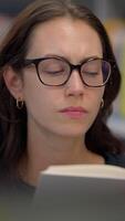 A Focused Woman Engaged in Deep Reading in a Modern and Contemporary Setting Environment video