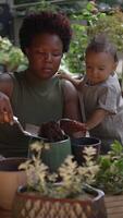 A mother and child engage in indoor gardening, fostering bonding and creativity video