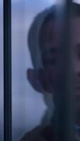 A reflective and contemplative man found in a bustling urban setting of the cityscape video