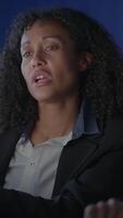 A Thoughtful and Professional Individual Engaging in a Meeting Setting with a Dark Background video