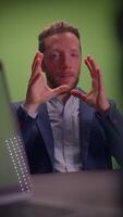 A Professional Man Engaging in a Conversation with a Green Screen Background Setting video