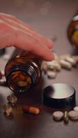 An assortment of various vitamins and nutritional supplements in bottles on a wooden surface video